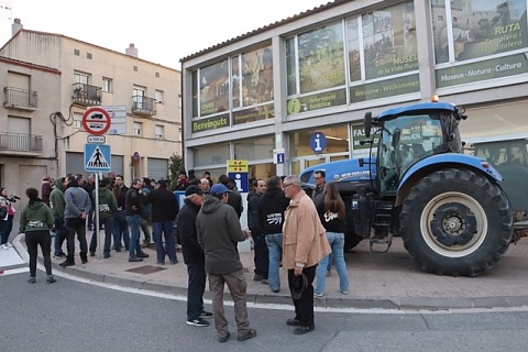 Diversos pagesos davant d'un tractor esperen el president de la Generalitat, Pere Aragonès