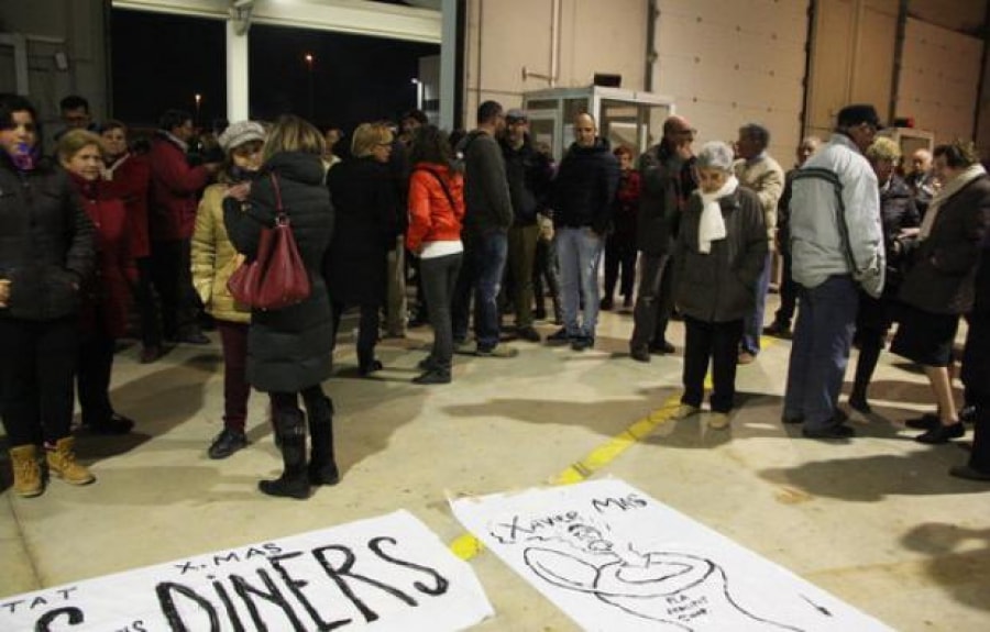 Un grup de persones s&#039;agrupen davant una pancarta durant la protesta a la Cooperativa Agrícola de Cambrils el 19 de febrer de 2016.